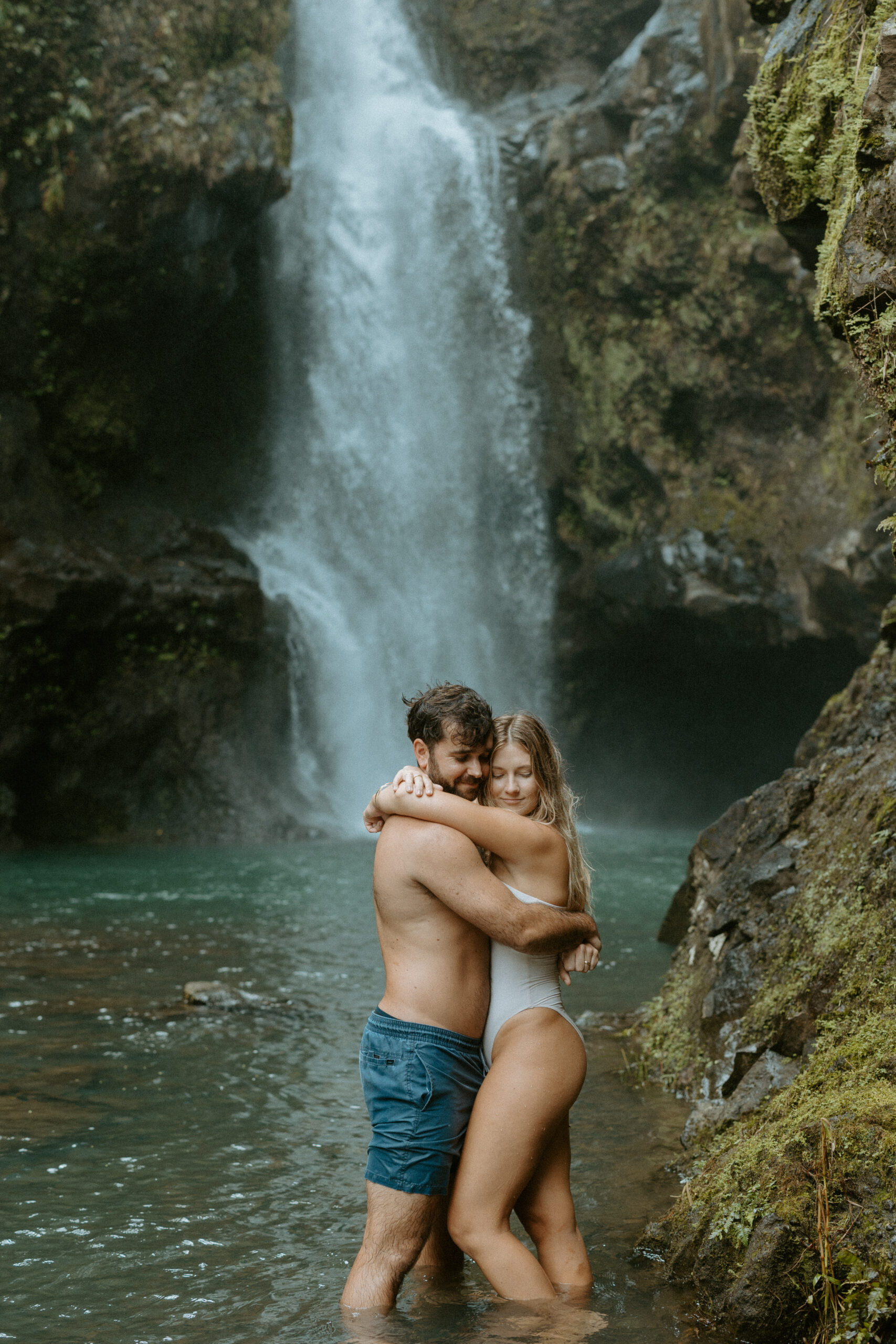 couple waterfall photoshoot in Maui, Hawaii man and women embracing